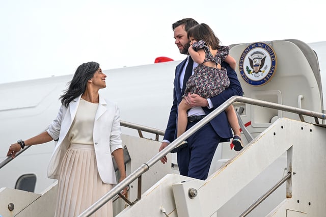 Usha Vance looks back at US Vice President JD Vance, carrying their daughter Mirabel, as they disembark Air Force Two upon arriving in Rome, Italy, on April 18.