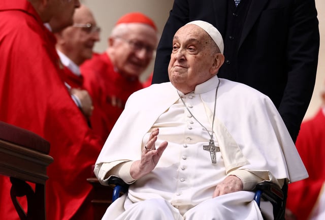 Pope Francis greets cardinals as he unexpectedly appears during the Palm Sunday Mass in Saint Peter's Square at the Vatican, April 13, 2025. REUTERS/Yara Nardi