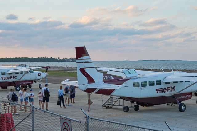 Tourists board a Tropic Air plane April 17 at the Sir Barry Bowen Municipal Airport in Belize City. A U.S. citizen armed with a knife attempted to hijack a small plane in Belize on Thursday but was shot and killed by a passenger, police said.