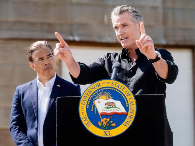California Gov. Gavin Newsom discusses President Donald Trump's tariffs, as California Attorney General Rob Bonta, left, listens, during a press conference on Wednesday, April 16, 2025, at an almond farm in Ceres, Calif. (AP Photo/Noah Berger)