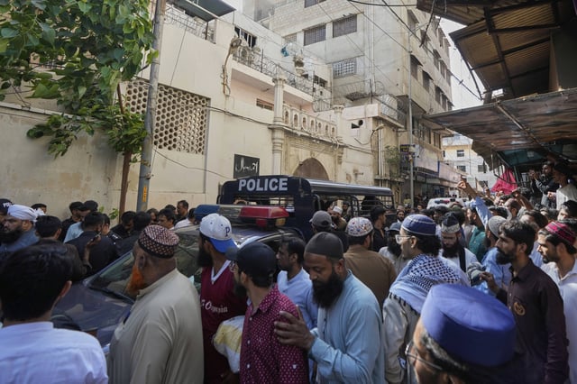 Police officers arrive to control the situation as supporters of Tehreek-e-Labbaik Pakistan or TLP party hold a demonstration against the Pakistan's minority Ahmadi community at outside their place of worship, in Karachi, Pakistan, Friday, April 18, 2025. (AP P hoto/Fareed Khan)
