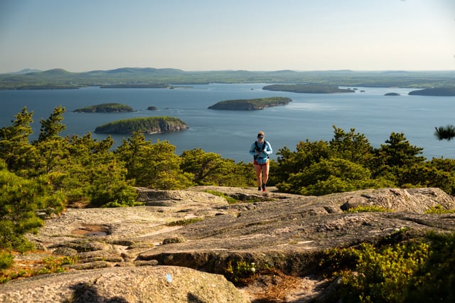A woman hikes on Granite Trail in Acadia National Park in Maine.