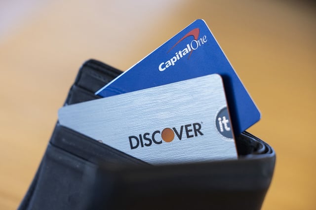 Capital One and Discover credit cards arranged in Germantown, New York, US, on Tuesday, Feb. 20, 2024.