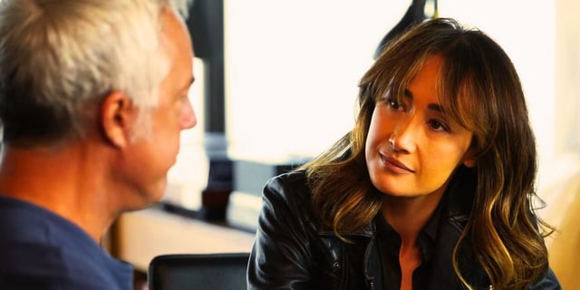 Maggie Q and Titus Welliver talking.