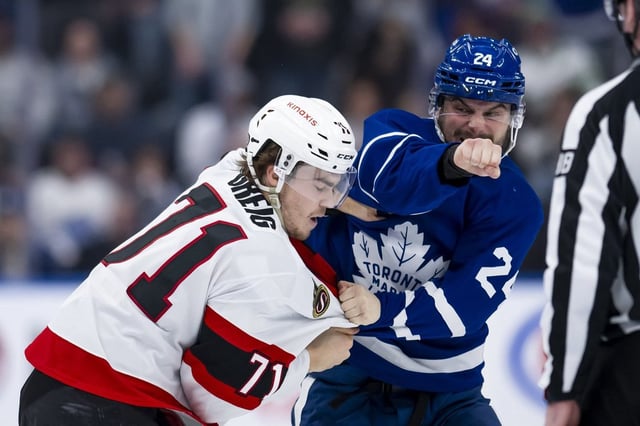 Toronto Maple Leafs forward Scott Laughton (24) and Ottawa Senators centre Ridly Greig (71) fight during second period NHL hockey action in Toronto on Saturday, March 15, 2025. THE CANADIAN PRESS/Christopher Katsarov