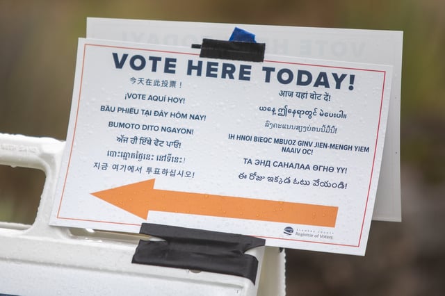 A sign points voters to an election polling location on election day in Oakland, Calif., on Nov. 8, 2022.