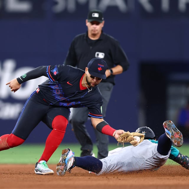 TORONTO, ON - APRIL 18: Julio Rodríguez #44 of the Seattle Mariners is tagged out by Bo Bichette #11 of the Toronto Blue Jays at second base in the eighth inning during a game at Rogers Centre on April 18, 2025 in Toronto, Ontario, Canada. (Photo by Vaughn Ridley/Getty Images)