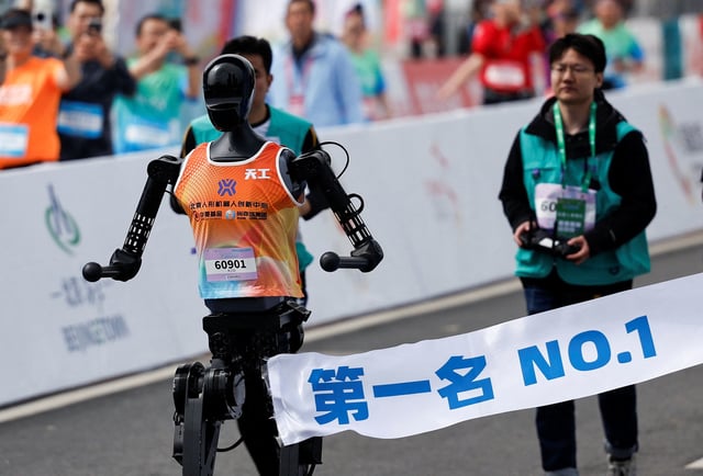 Tiangong Ultra, a humanoid robot, runs across the finish line while securing the first position during the E-Town Humanoid Robot Half Marathon, in Beijing, China, on April, 19 2025.