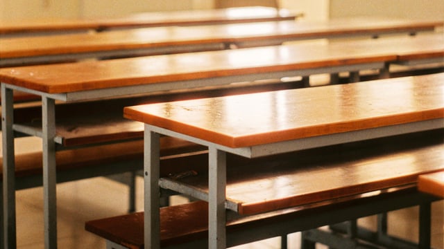 The purported video shows the teacher offering a drink to young boys in cups in a room. 