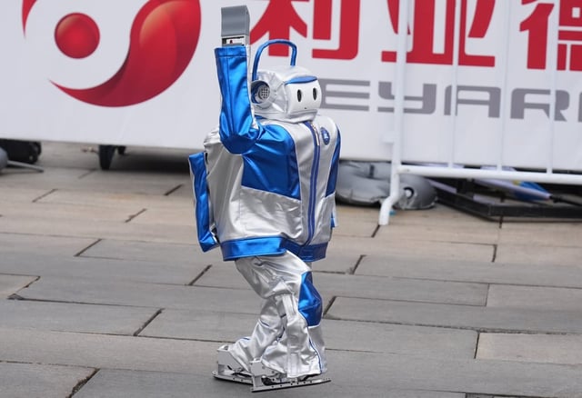 One of the robots waves to the crowd. Photo: Xinhua