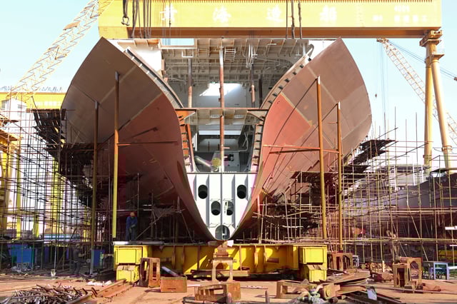 Workers are seen near a vessel under construction at a shipyard of Huanghai Shipbuilding Co in Weihai, Shandong province, China November 6, 2018. Picture taken November 6, 2018.  REUTERS/Stringer ATTENTION EDITORS - THIS IMAGE WAS PROVIDED BY A THIRD PARTY. CHINA OUT./File Photo