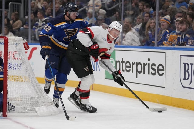 Ottawa Senators' Brady Tkachuk (7) controls the puck as St. Louis Blues' Ryan Suter (22) defends during the first period of an NHL hockey game Friday, Jan. 3, 2025, in St. Louis. (AP Photo/Jeff Roberson)