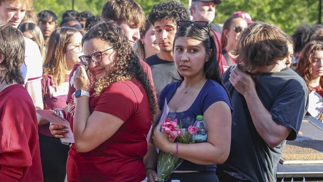 The day after an active shooter on campus, Florida State students place electronic candles on a platform during a vigil on campus at Langford Green, Tallahassee, Fla., Friday, April 18, 2025.