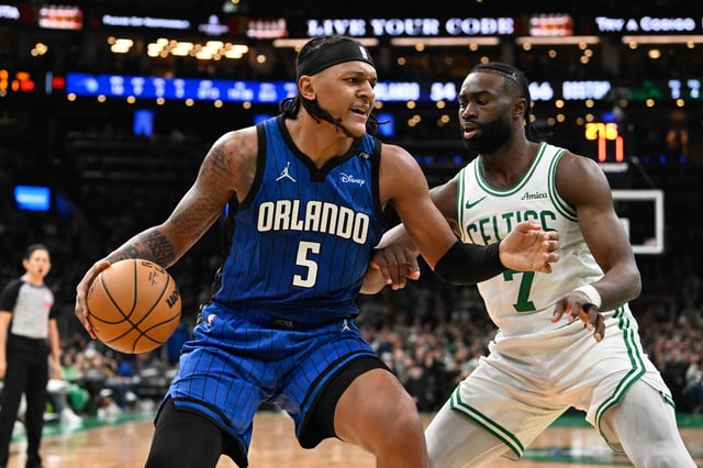 Magic forward Paolo Banchero looks to make a move on Celtics guard Jaylen Brown during the teams' January 17 game in Boston.