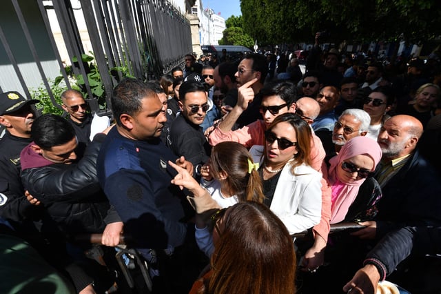 Chaima Issa (3rd-R), Tunisian journalist, human rights defender and member of the main opposition coalition (FSN), arrives in front of the courthouse in Tunis, as the trial of dozens of Tunisian opposition figures resumed on April 11, 2025. Around 40 high-profile defendants activists, politicians, lawyers and media figures are on trial, some of whom have been vocal critics of President Kais Saied. (Photo by FETHI BELAID / AFP) (Photo by FETHI BELAID/AFP via Getty Images)