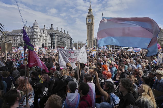 Campaigners take part in a rally organised by trans rights groups, trade unions, and community organisations following the Supreme Court ruling on the definition of a woman in equalities law, at Parliament Square, central London, Saturday April 19, 2025. (AP Photo/Alastair Grant)