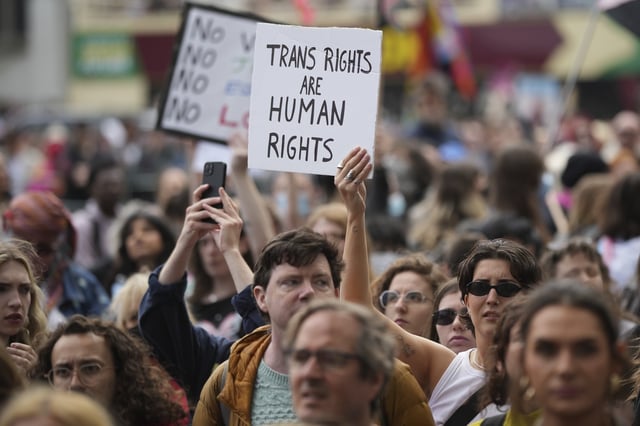 Campaigners take part in a rally organised by trans rights groups, trade unions, and community organisations following the Supreme Court ruling on the definition of a woman in equalities law, at Parliament Square, central London, Saturday April 19, 2025. (AP Photo/Alastair Grant)