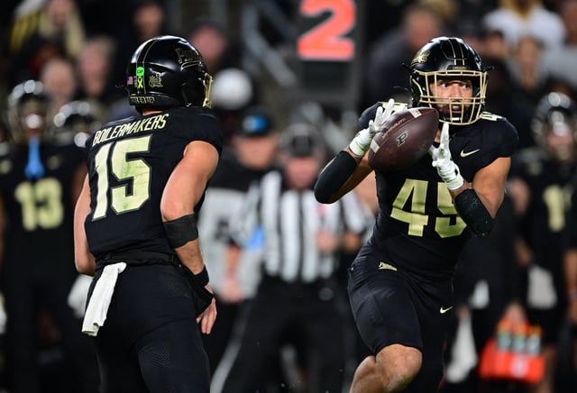 Oct 18, 2024; West Lafayette, Indiana, USA; Purdue Boilermakers quarterback Ryan Browne (15) pitches the ball to running back Devin Mockobee (45) during the second half against the Oregon Ducks at Ross-Ade Stadium. Mandatory Credit: Marc Lebryk-Imagn Images/File Photo