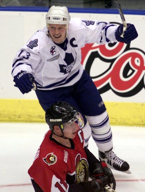 Ottawa Senators captain Daniel Alfredsson (11) skates back to the bench as Toronto Maple Leafs captain Mats Sundin (13) celebrates teammate Steve Thomas' game tying goal during third period NHL playoff action in Toronto on Saturday April 22, 2000. (CP PHOTO/Kevin Frayer)