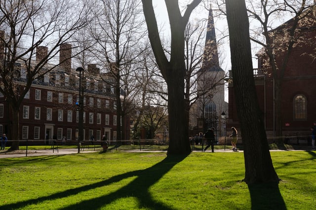 People walk through campus at Harvard University on April 17, 2025, in Cambridge, Massachusetts. The Trump administration announced that it would block Harvard University from receiving $2.2 billion in federal grants and $60 million in contracts after the school refused demands to adopt new policies relating to student and faculty conduct, admissions, anti-semitism on campus and DEI.