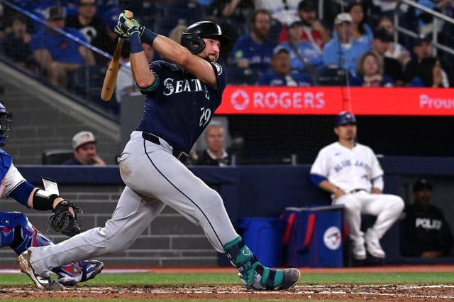 Seattle Mariners catcher Cal Raleigh (29) hits a two-run double against the Toronto Blue Jays in fifth inning American League baseball action in Toronto on Saturday, April 19, 2025. THE CANADIAN PRESS/Jon Blacker