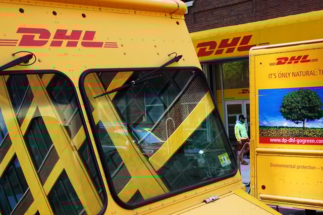 Trucks are parked outside a DHL delivery facility in Manhattan, New York City, U.S., May 9, 2022. REUTERS/Andrew Kelly