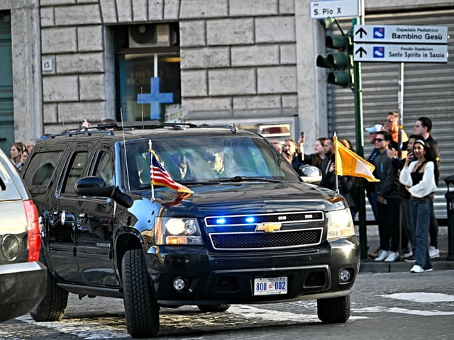 The car of U.S. Vice President JD Vance with the flag of the Holy See leaves the Vatican to reach Castel Sant'Angelo after the celebration of the Passion of the Lord as part of the Holy Week, in Rome on April 18, 2025. (Photo by Alberto PIZZOLI / AFP)