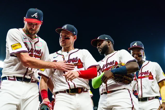Chris Sale #51, Jarred Kelenic #24, Michael Harris II #23 and Ronald Acuña Jr. #13 of the Atlanta Braves walk off the field in the sixth inning against the Boston Red Sox at Truist Park on May 8, 2024 in Atlanta, Georgia.