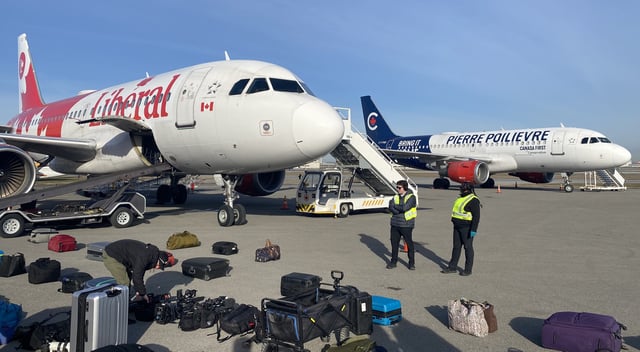 The campaign planes for the Liberals and the Conservatives await their leaders after the debates in Montreal on April 18, 2025. 