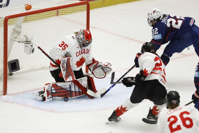 Ice Hockey - IIHF Women's World Championships - Gold Medal Game - United States v Canada - Budvar Arena, Ceske Budejovice, Czech Republic - April 20, 2025 Canada's Ann-Renee Desbiens in action with Tessa Janecke of the U.S. REUTERS/David W Cerny