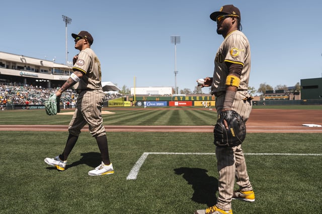Manny Machado #13 and Luis Arraez #4 of the San Diego Padres stand on the field before the game against the Athletics at Sutter Health Park on April 09, 2025 in Sacramento, California.