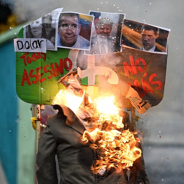 SupporterS of Venezuelan President Nicolas Maduro set fire to a rag doll with pictures of (L-R) El Salvador's President Nayib Bukele, opposition leaders Maria Corina Machado and Edmundo Gonzalez, US President Donald Trump, opposition leader Juan Guaida, and Guyana's President Irfaan Ali, during the traditional Judas burning within the Holy Week celebrations in Caracas on April 20, 2025. (Photo by Juan BARRETO / AFP) (Photo by JUAN BARRETO/AFP via Getty Images)