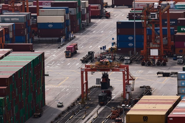 A truck carrying containers moves at the Yantian port in Shenzhen, Guangdong province, China April 17, 2025. REUTERS/Tingshu Wang/File Photo