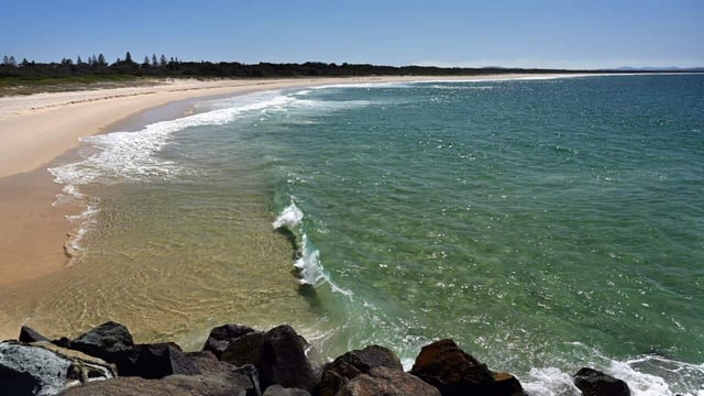 The boy died on Sunday after being caught between rocks, taking the death toll from what surf lifesavers have called the "worst Easter long weekend" they've seen in years to seven.
