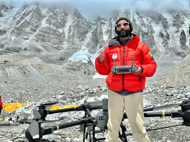 Drone pilot Milan Pandey stands at Everest Base Camp.