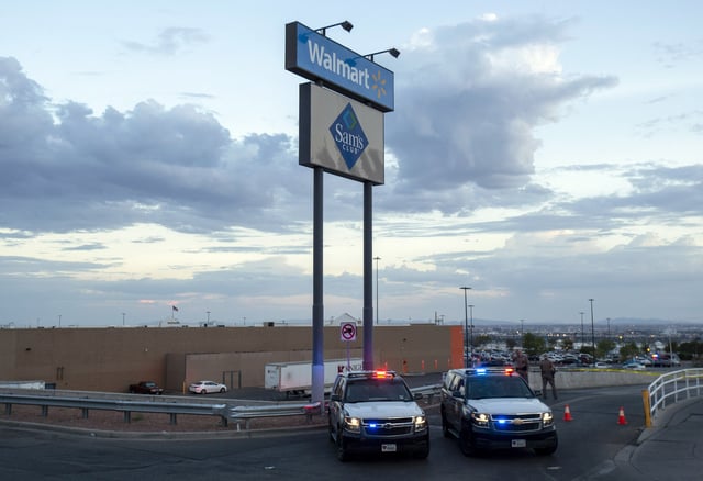 FILE - In this Aug. 3, 2019, photo Texas state police cars block the access to the Walmart store in the aftermath of a mass shooting in El Paso, Texas. (AP Photo/Andres Leighton, File)
