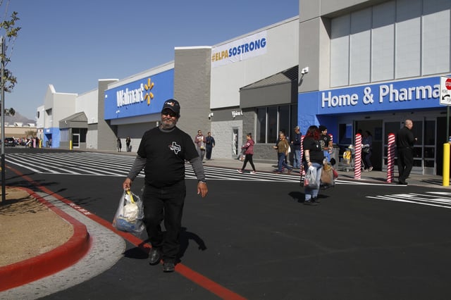 FILE - Eddie Medina, 62, carries groceries he bought for his wife at the reopening of the Cielo Vista Walmart, Thursday, Nov. 14, 2019, in El Paso, Texas. (AP Photo/Cedar Attanasio, File)
