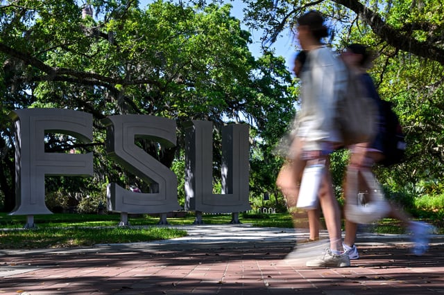 TALLAHASSEE, FLORIDA - APRIL 18: Florida State University students walk near the scene of a shooting near the Florida State University student center on April 18, 2025 in Tallahassee, Florida. Two people were reported dead and several others injured when the suspected shooter, believed to be a student and the son of a Leon County Sheriff deputy, opened fire on the university main campus. (Photo by Miguel J. Rodriguez Carrillo/Getty Images)