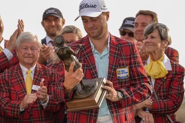 Apr 20, 2025; Hilton Head, South Carolina, USA; Justin Thomas holds his trophy and wears the plaid jacket after winning the final round of the RBC Heritage golf tournament. Mandatory Credit: Jim Dedmon-Imagn Images