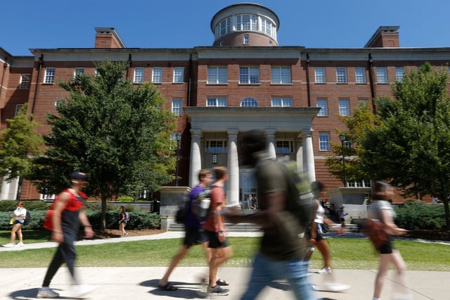Students walk on the first day of fall classes at the University of Georgia in Athens, Georgia, on August 18, 2021.