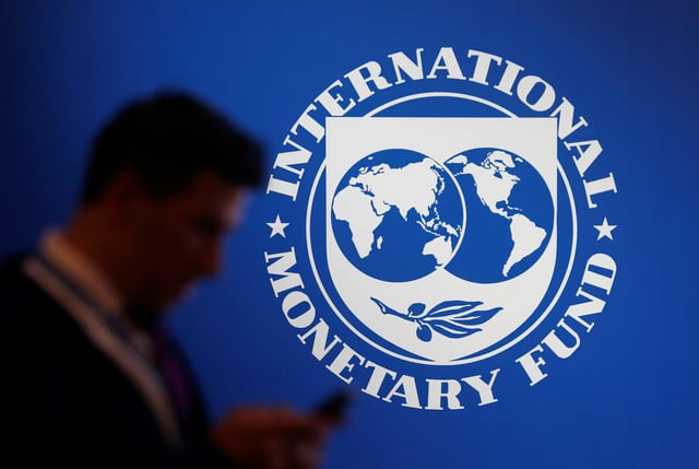 A participant stands near a logo of IMF at the International Monetary Fund - World Bank Annual Meeting 2018 in Nusa Dua, Bali, Indonesia, October 12, 2018. REUTERS/Johannes P. Christo