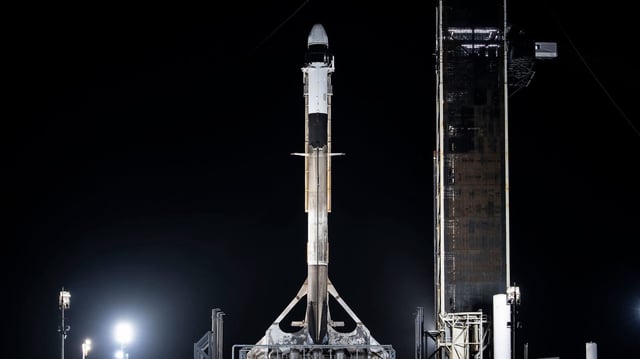 A SpaceX Falcon 9 rocket, with the company’s Dragon spacecraft atop, stands in a vertical position at Launch Complex 39A at NASA’s Kennedy Space Center in Florida