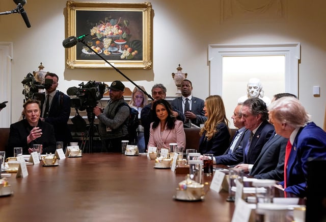 US President Donald Trump listens as Tesla CEO Elon Musk speaks during a Cabinet meeting at the White House on April 10.