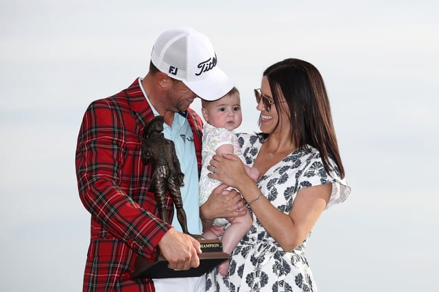 Justin Thomas of the United States poses with wife, Jillian Wisniewski, daughter, Molly Grace, and the championship trophy after winning the final round of the RBC Heritage 2025 at Harbour Town Golf Links