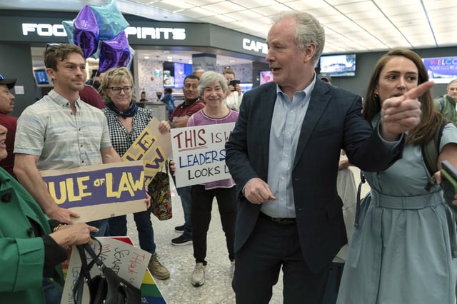 Sen. Chris Van Hollen, D-Md., is welcomed by supporters upon his arrival from meeting with Kilmar Abrego Garcia in El Salvador, at Washington Dulles International Airport, in Chantilly, Va., Friday, April 18, 2025. (AP Photo/Jose Luis Magana)