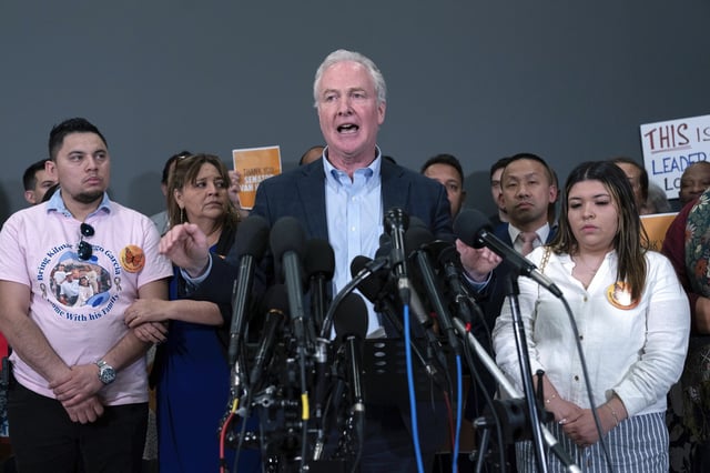 Sen. Chris Van Hollen, D-Md., center, accompanied by Cesar Abrego Garcia, from left, Cecilia Garcia and Jennifer Vasquez Sura, speaks during a news conference upon his arrival from meeting with Kilmar Abrego Garcia in El Salvador, at Washington Dulles International Airport, in Chantilly, Va., Friday, April 18, 2025. (AP Photo/Jose Luis Magana)