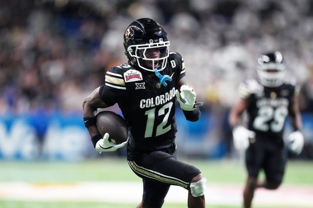 Colorado wide receiver Travis Hunter #12 runs for a touchdown against BYU after making a catch during the second half of the Alamo Bowl NCAA college football game, in San Antonio, on Dec. 28, 2024.