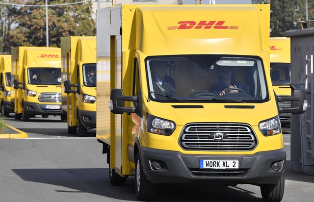 Deutsche Post StreetScooter Work XL electric delivery vans drive at the Ford car plant in Cologne, Germany, Tuesday, Oct. 9, 2018.