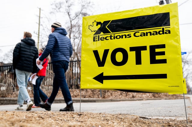 People make their way to and from an advance polling station in Ottawa, on Friday, April 18, 2025. Advance polls opened Friday for voters to cast their ballot in the federal election ahead of the April 28 official election day. 