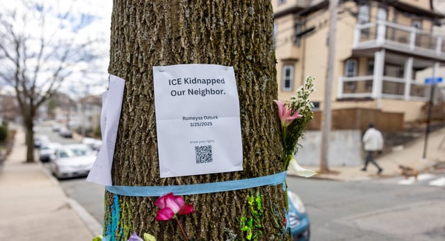 Signage and flowers are placed on a tree next to where ICE agents apprehended Tuft University graduate student Rumeysa Ozturk on March 27, 2025 in Somerville, Massachusetts. Ozturk was arrested for purported activities related to terrorist organizations amid the Trump administration's immigration crackdown. (Photo by Scott Eisen/Getty Images)